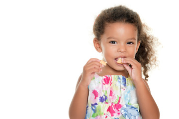 cute small girl eating a cookie