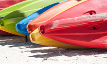Colored Kayaks On The Beach