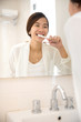 © Odua Images - Asian young woman tooth brushing her teeth happily