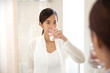 © Odua Images - Asian young woman gargle on her mouth after tooth brushing