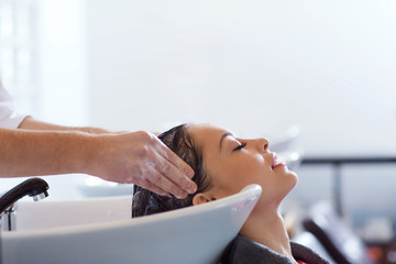 happy young woman at hair salon