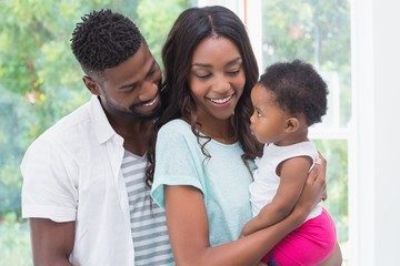 Wall Mural - Happy parents with baby girl