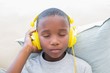 © WavebreakmediaMicro - Little boy listening to music on the couch