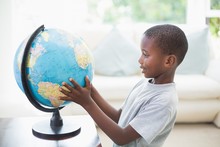 Little Boy Looking At The Globe