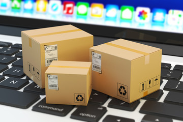 Internet shopping, online purchase, e-commerce and packages delivery concept, merchandise cardboard boxes on laptop keyboard