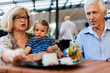 © Dangubic - Grandparents With Their Grandson At Cafe