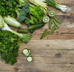 Raw detox green vegetable food set on wood table