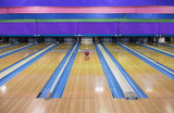 Generic Bowling Alley lanes with bowling ball going towards the pins