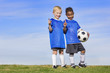© Brocreative - Two diverse young soccer players showing No. 1 sign. Full length view of two youth recreation league soccer players