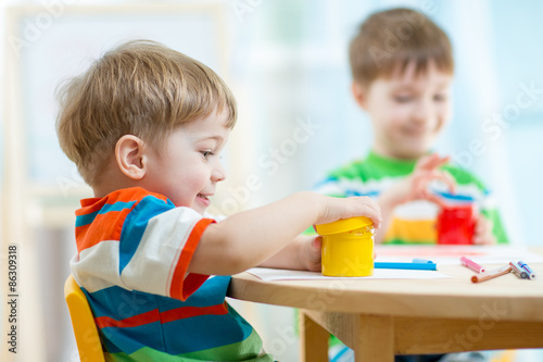 Valokuva children play and paint at home or kindergarten or playschool or daycare
