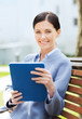 © Syda Productions - smiling business woman with tablet pc in city