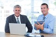 © WavebreakmediaMicro - Businessmen working together with laptop and tablet