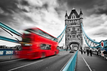 Fototapete - Red bus in motion on Tower Bridge in London, the UK