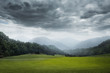 canvas print picture - green meadow and cloudy sky
