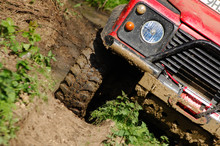 Landrover Defender Off Road At An Angle On Mud Track On A 4x4 Adventure Trip