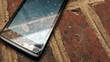 Broken screen old cell phone on brick ground. selective focus image