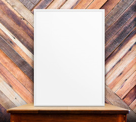 Fototapete - Empty white frame on wooden table at tropical diagonal wood wall