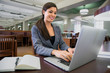 © elnariz - Business woman executive in the library researching attorney lawyer