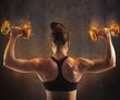 © alphaspirit - Woman training with  fiery dumbbells