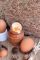 Wall Mural - soft-boiled egg and eggs on wood background