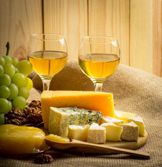 Wall Mural - White wine with cheese, honey, walnuts and grapes on sackcloth