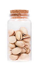 Pistachios in a glass bottle with cork stopper, isolated on whit