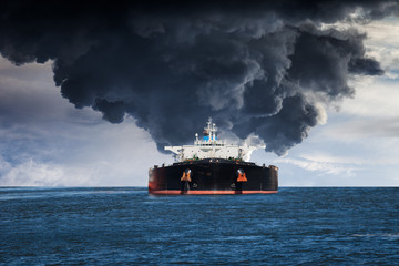 burning tanker ship on the sea.