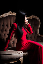 Beautiful Lady In Red Dress On Luxury Sofa