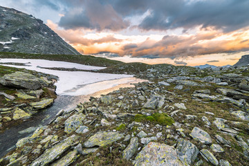 Wall Mural - High altitude alpine lake and cloudscape at sunset