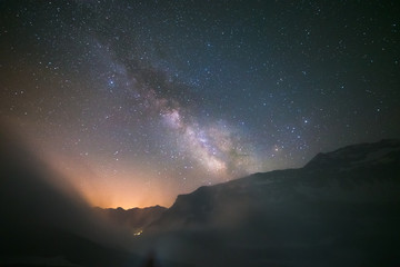 Wall Mural - idyllic milky way with clouds and fog in the alps
