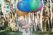 Girl with an armful of balloons