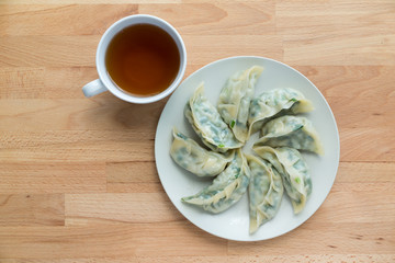 Sticker - Meat dumpling with a cup of tea