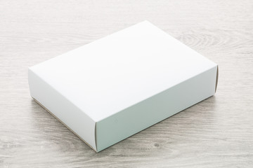 Sticker - Paper box on wood background