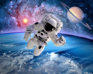 Wall Mural - astronaut spaceman outer space saturn planet earth sun. elements of this image furnished by nasa.