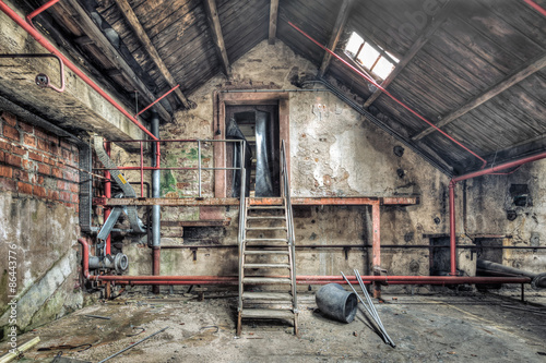 Fototapeta na wymiar Metal staircase in an abandoned workshop