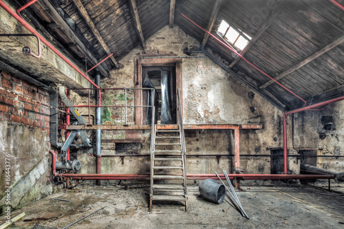 Obraz w ramie Metal staircase in an abandoned workshop