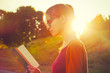 girl reading book in summer sunset light