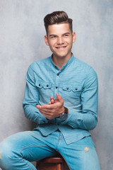 Poster - young man holding his hands together.