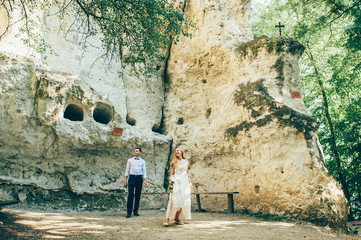 wedding couple near rock