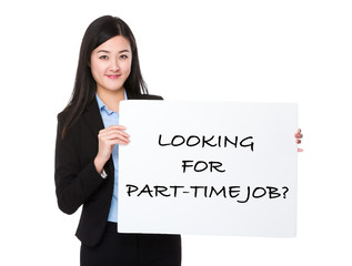 Confident businesswoman holding a poster showing with looking fo