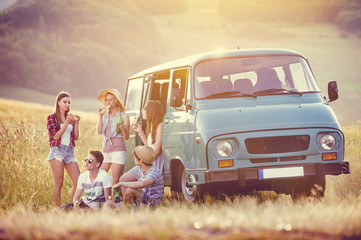 Wall Mural - Young hipster friends on road trip