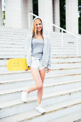 Canvas Print - Girl standing on stairs with skateboard