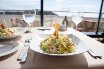 Wall Mural - seafood salad served on white plate in restaurant