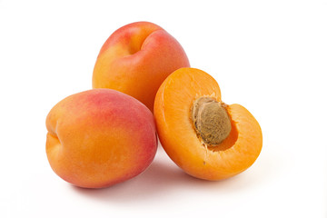 Two and half apricot with a stone on a white background