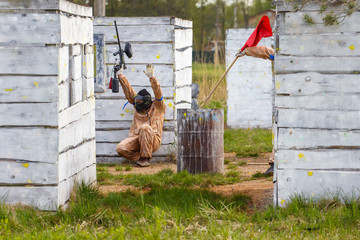 Wall Mural - Extreme capture of red flag in paintball game