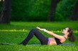 © dojo666 - Sports girl does exercises workout outdoors in park