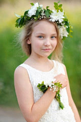 Wall Mural - portrait of a beautiful little girl with flowers