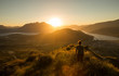 © naruedom - Woman silhouette at sunset on the mountain
