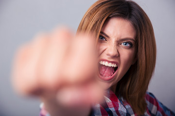 Woman hitting with fist on camera and shouting