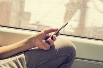 Wall Mural - young man using a smartphone in a train or a subway